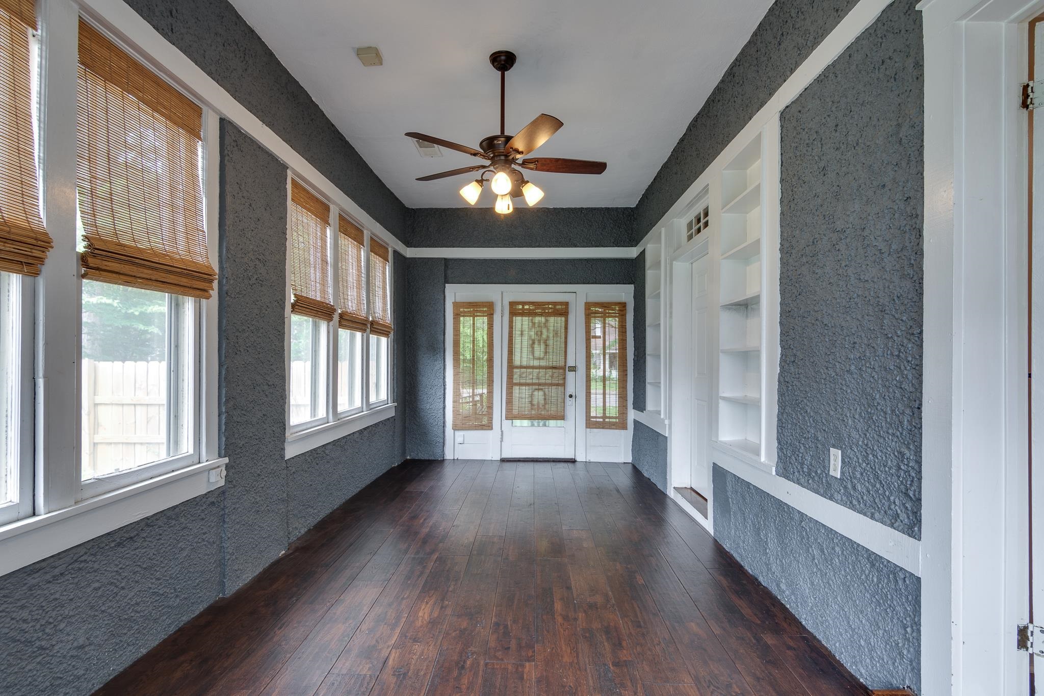 520 Ellsworth Street Memphis, TN 38111 - Photo 19 of 37 Unfurnished sunroom featuring a textured wall, plenty of natural light, hardwood / wood-style flooring, and french doors