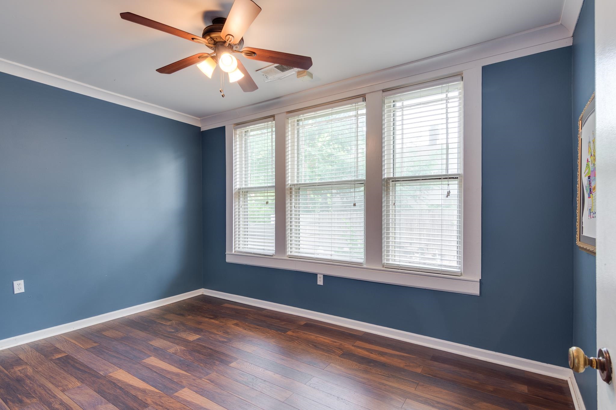 520 Ellsworth Street Memphis, TN 38111 - Photo 21 of 37 Spare room featuring ornamental molding, dark wood-style flooring, and a ceiling fan