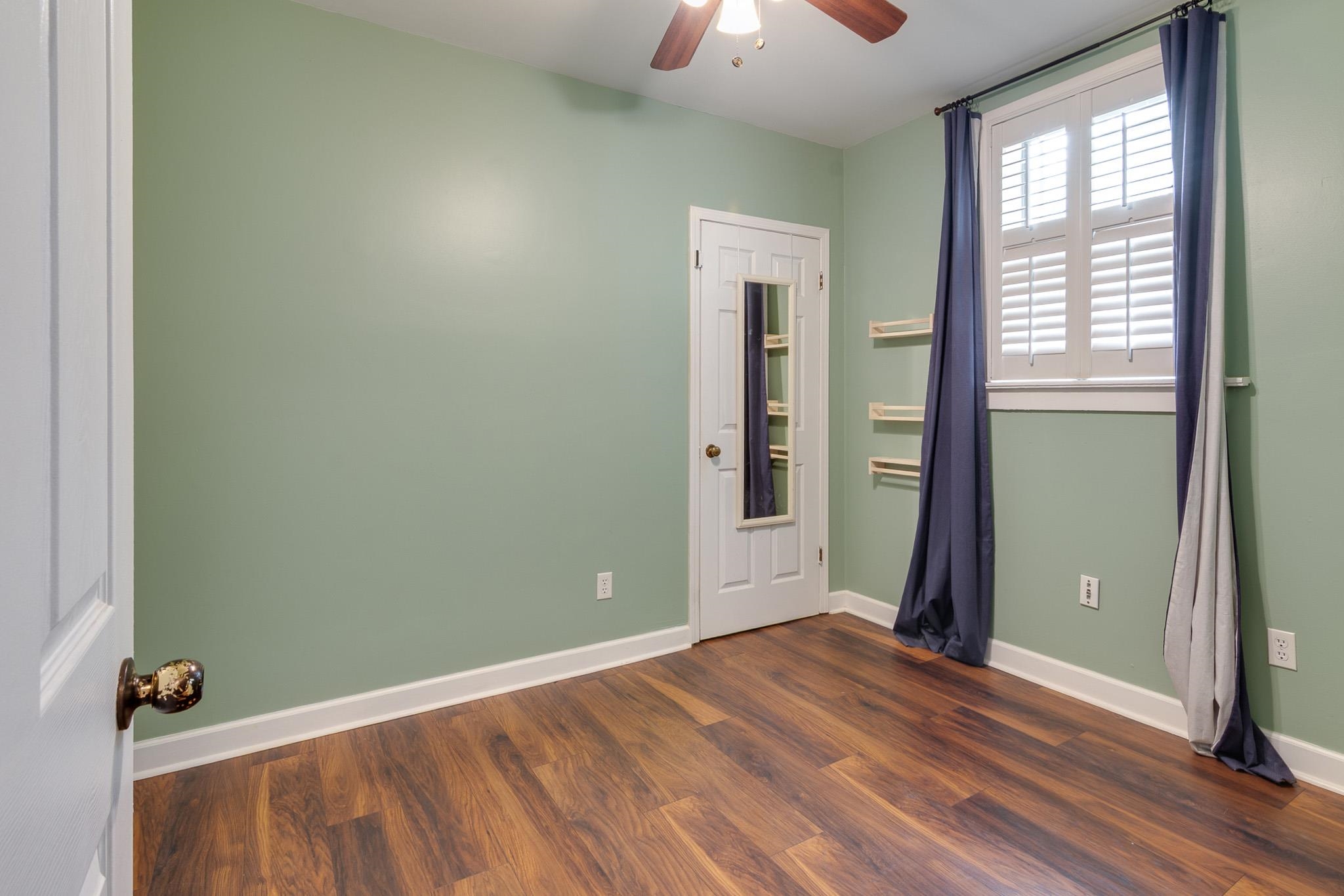 520 Ellsworth Street Memphis, TN 38111 - Photo 27 of 37 Unfurnished bedroom with dark wood-style floors and ceiling fan