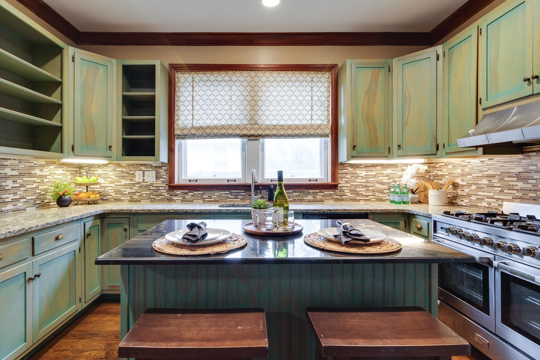 520 Ellsworth Street Memphis, TN 38111 - Photo 10 of 37 Two tone kitchen with a center island, double oven range, light stone countertops, a kitchen breakfast bar, and dark wood-style floors