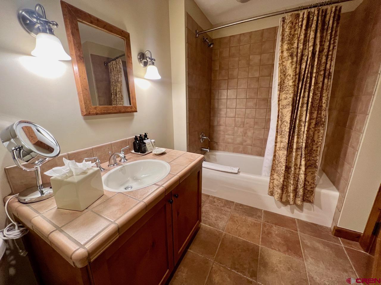 620 Gothic Road, Unit 606 Crested Butte, CO 81225 - Photo 13 of 28 a bathroom with a sink and a mirror