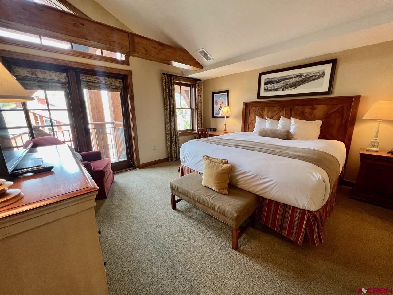 620 Gothic Road, Unit 606 Crested Butte, CO 81225 - Photo 15 of 28 a bedroom with a bed and wooden floor