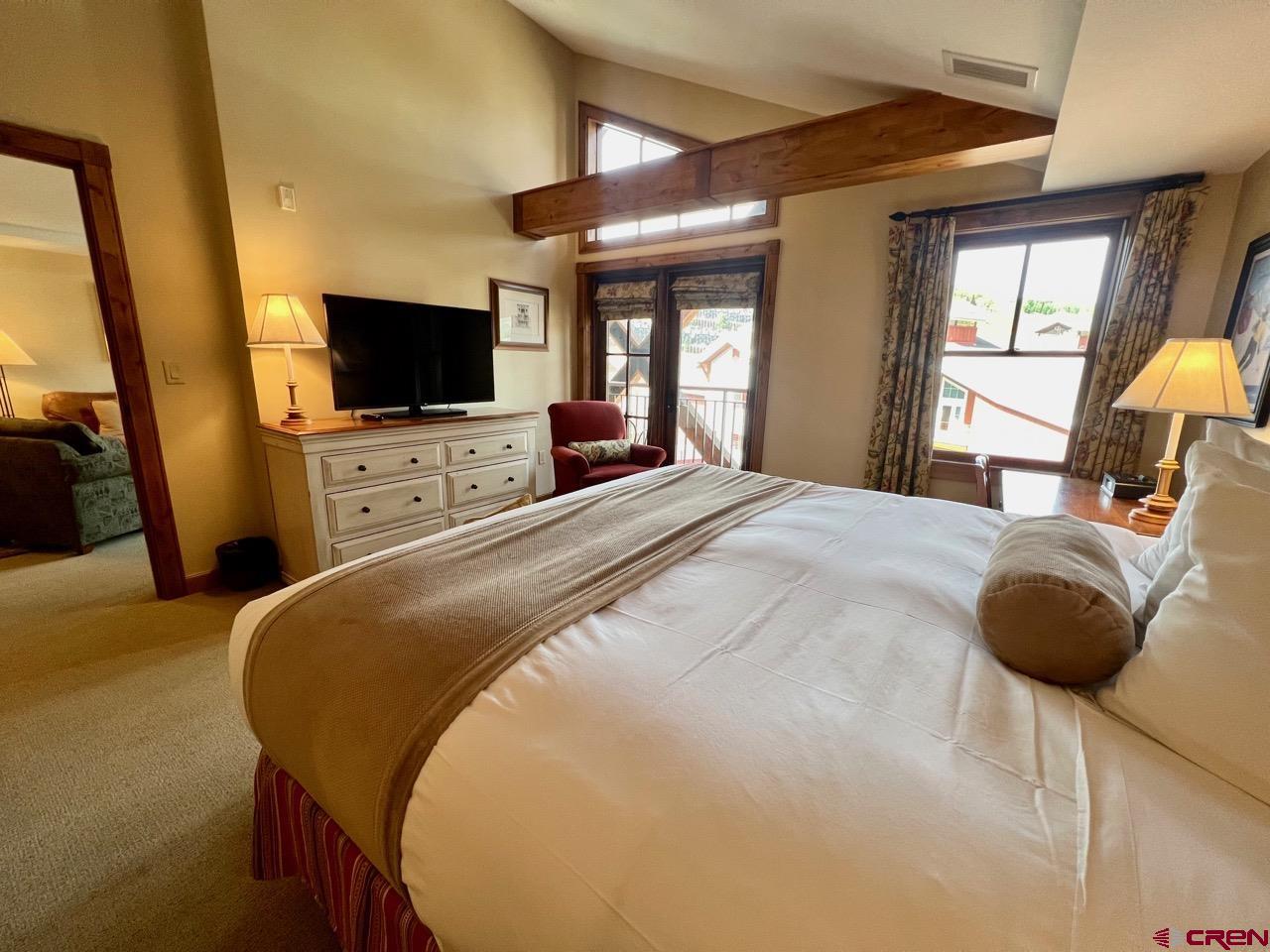 620 Gothic Road, Unit 606 Crested Butte, CO 81225 - Photo 16 of 28 a bedroom with a bed and a flat screen tv