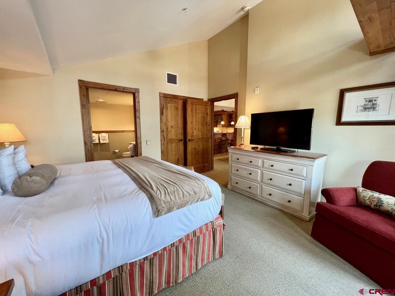 620 Gothic Road, Unit 606 Crested Butte, CO 81225 - Photo 17 of 28 a bedroom with a bed and a flat screen tv