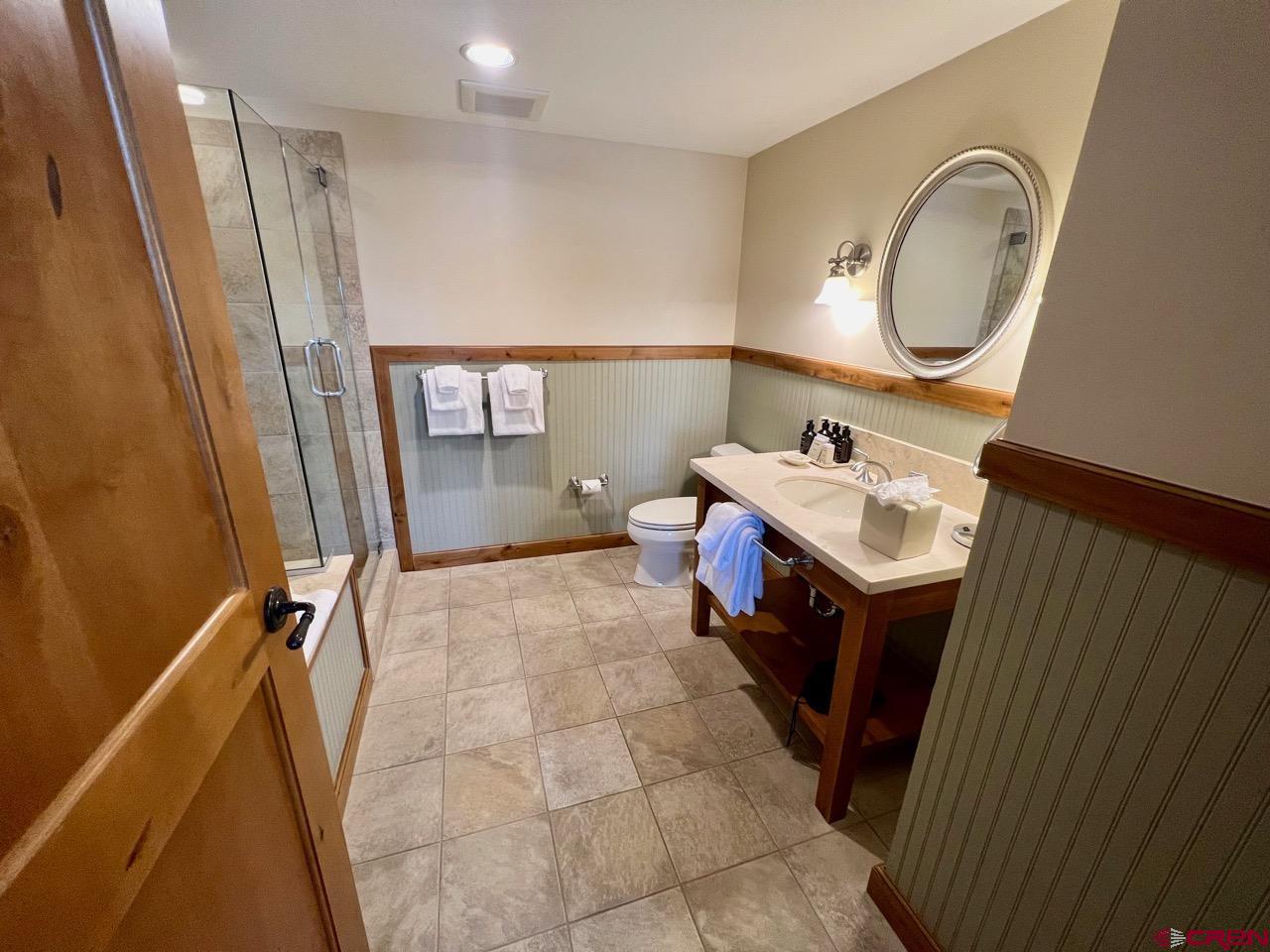 620 Gothic Road, Unit 606 Crested Butte, CO 81225 - Photo 18 of 28 a bathroom with a sink vanity mirror and tub