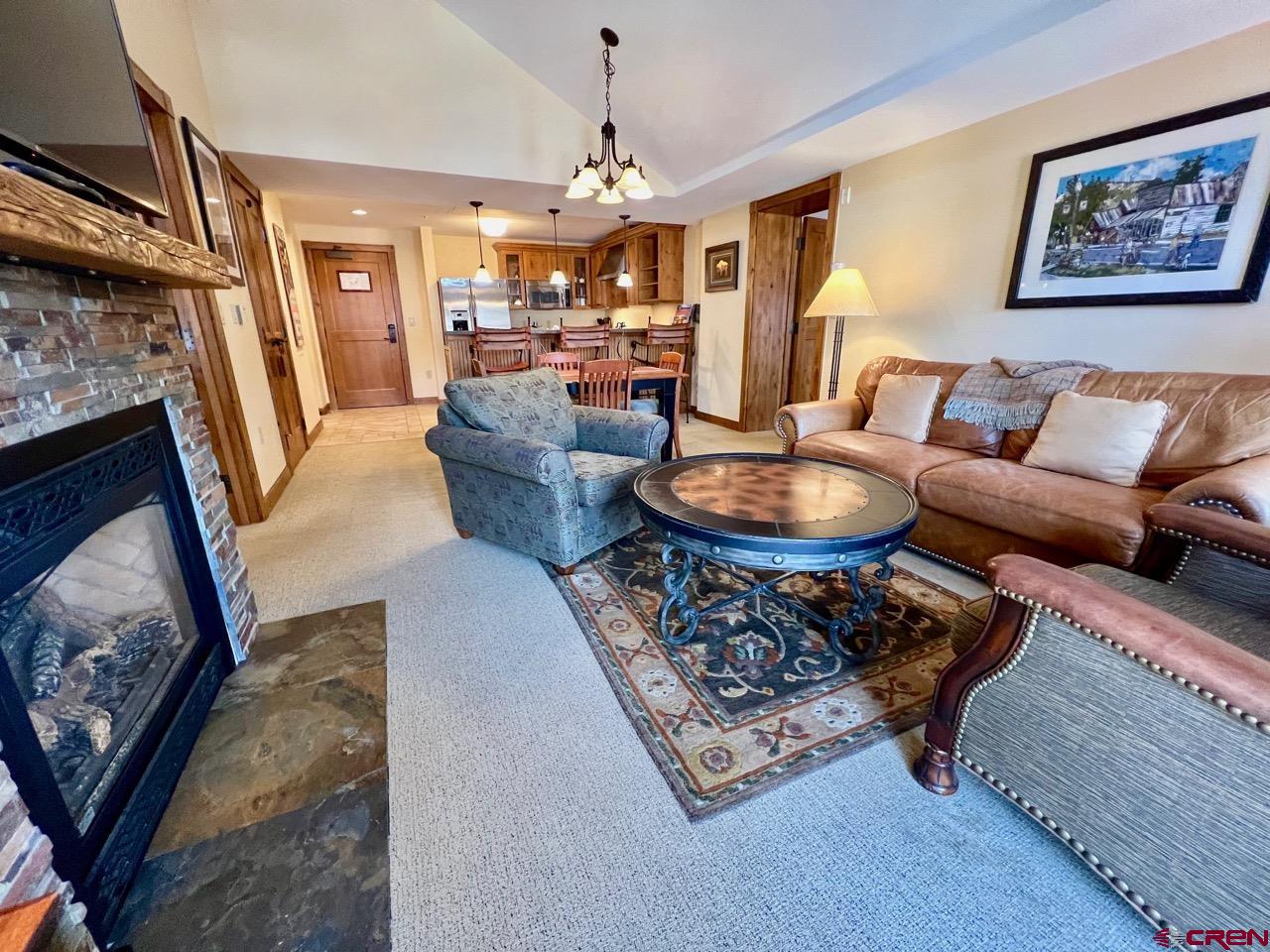 620 Gothic Road, Unit 606 Crested Butte, CO 81225 - Photo 4 of 28 a living room with furniture and a chandelier