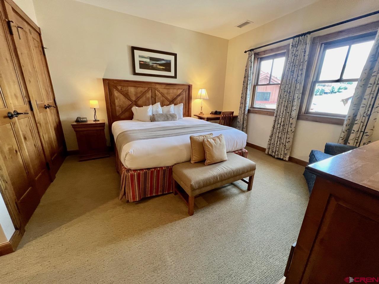 620 Gothic Road, Unit 606 Crested Butte, CO 81225 - Photo 8 of 28 a bedroom with a bed couch and a window