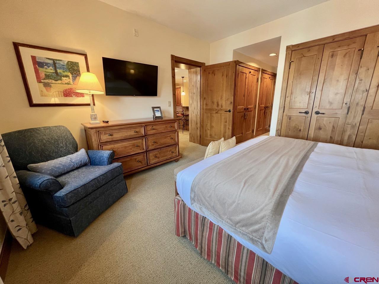 620 Gothic Road, Unit 606 Crested Butte, CO 81225 - Photo 10 of 28 a bedroom with furniture and a flat screen tv