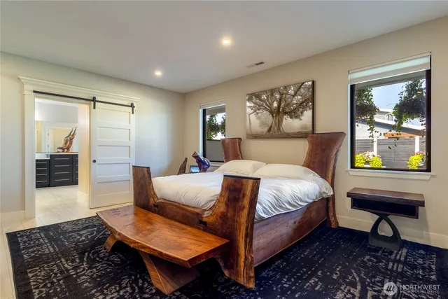 a spacious bedroom with a bed and window