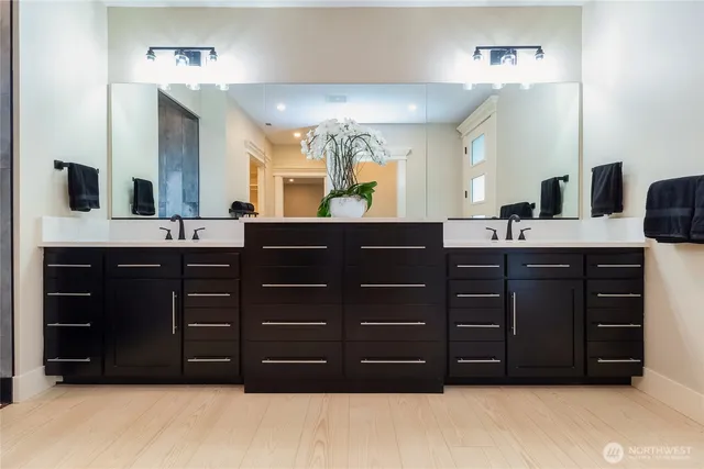 a bathroom with a sink vanity and a mirror
