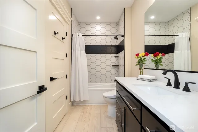 a bathroom with a double vanity sink mirror and shower