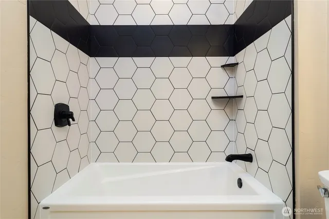 a bathroom with a bathtub and shower