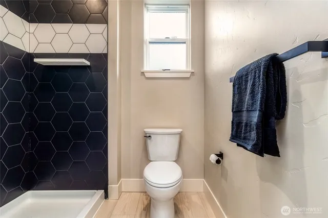 a bathroom with a toilet and a shower