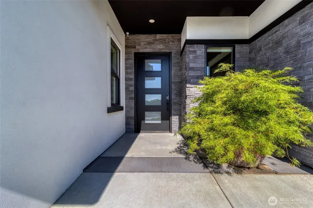 a pathway of a house with a yard