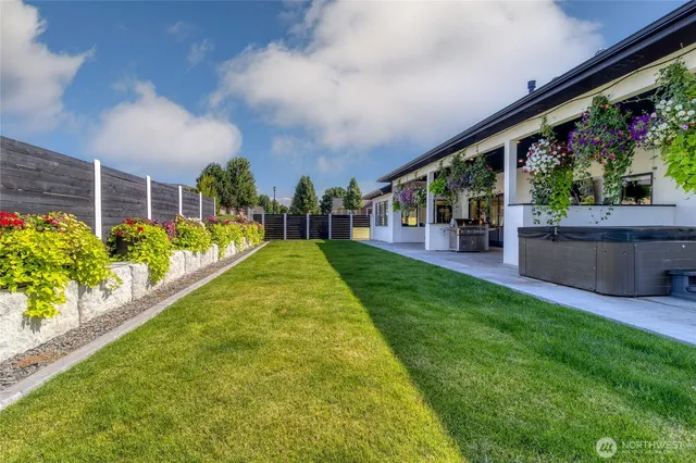 a swimming pool with outdoor seating and garden