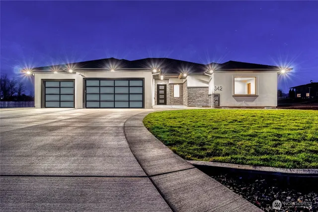 a front view of a house with a yard and garage