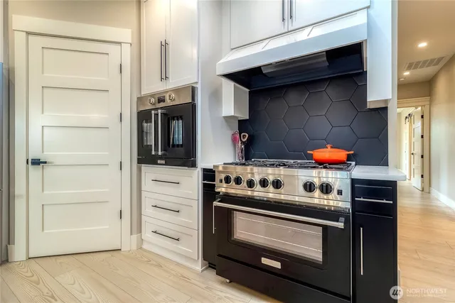 a kitchen with stainless steel appliances and wooden cabinets