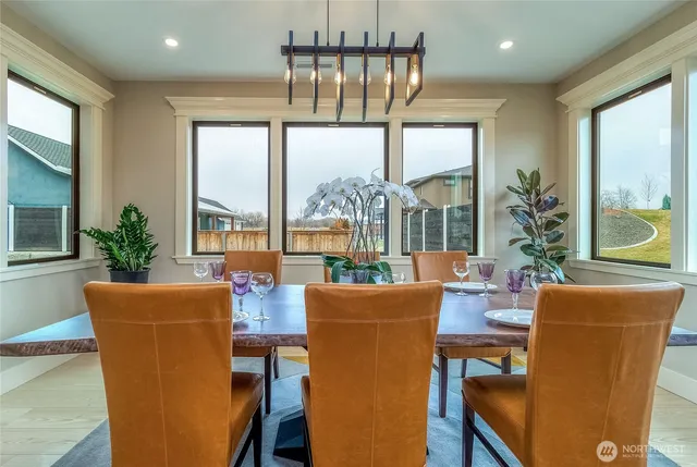 a dining room with furniture a chandelier and wooden floor