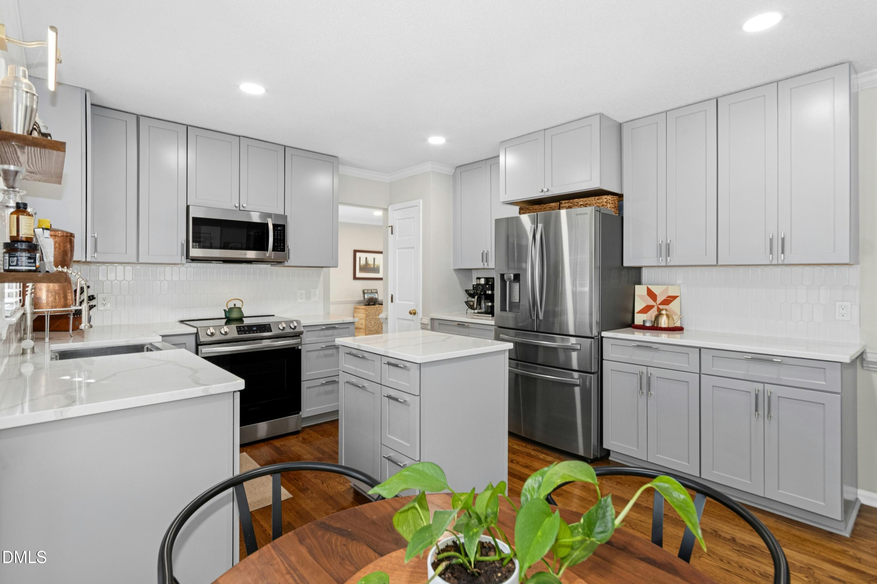 8616 Vanburgh Court Raleigh, NC 27615 - Photo 12 of 38 a kitchen with a sink appliances and cabinets