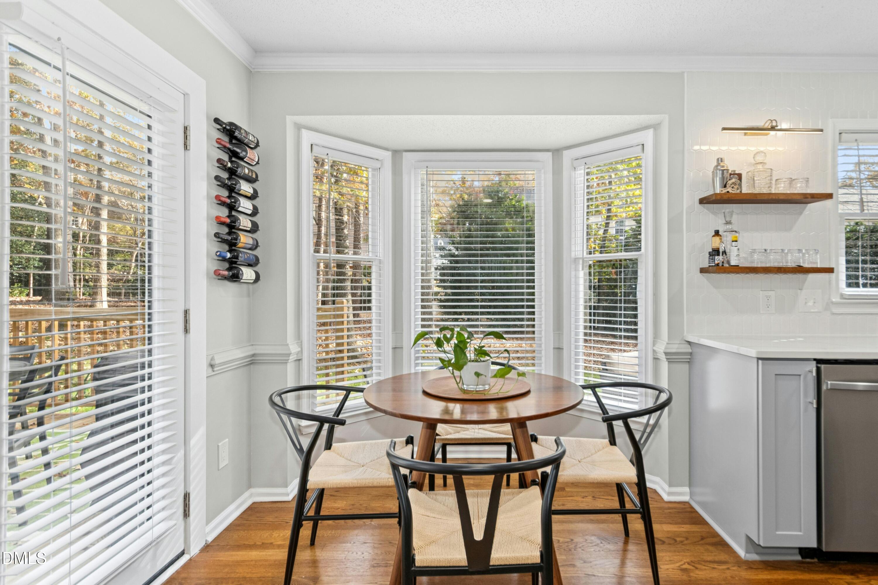 8616 Vanburgh Court Raleigh, NC 27615 - Photo 13 of 38 a view of a dining room with furniture window and wooden floor