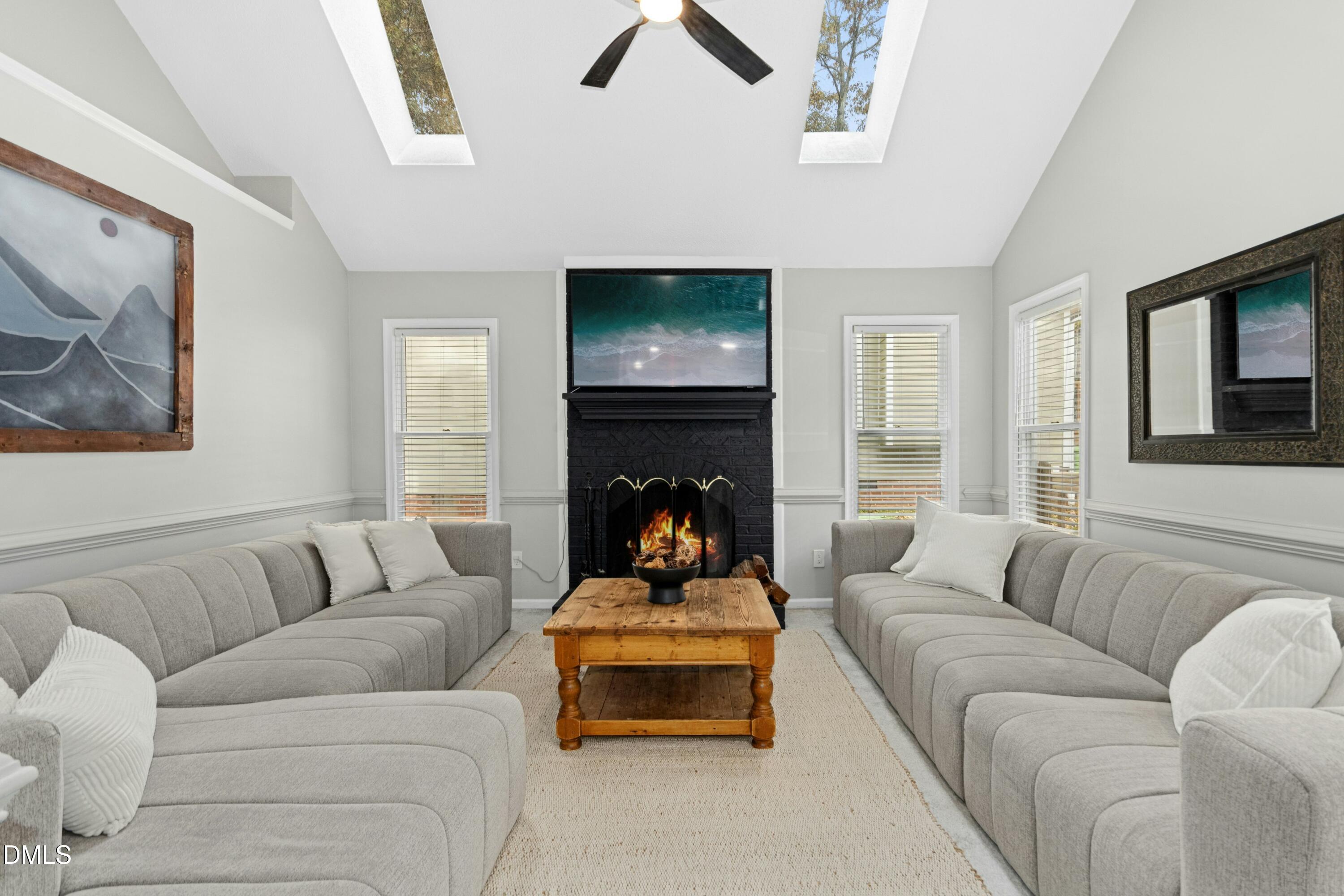 8616 Vanburgh Court Raleigh, NC 27615 - Photo 15 of 38 a living room with furniture and a fireplace