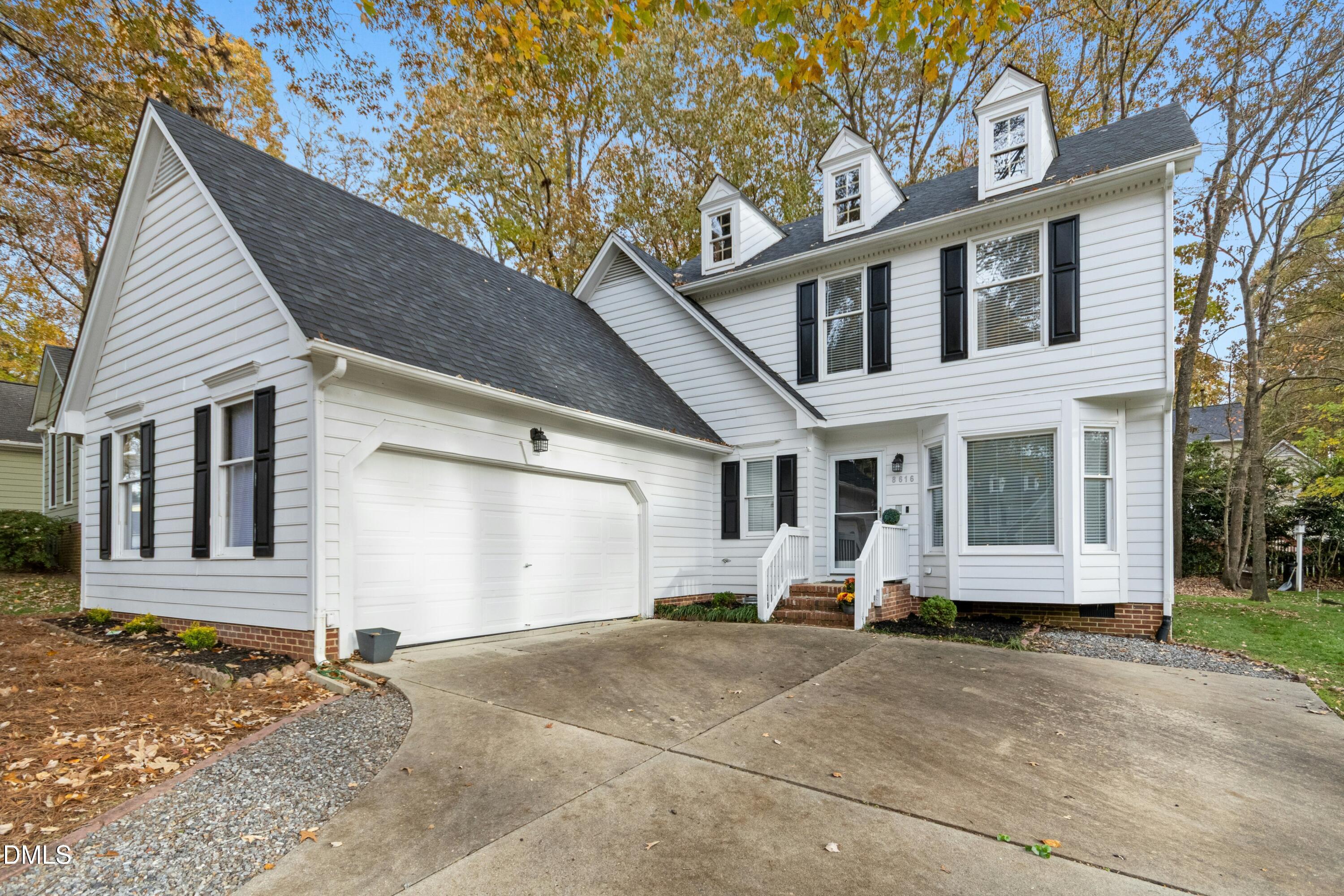 8616 Vanburgh Court Raleigh, NC 27615 - Photo 2 of 38 a view of a white house with a large windows