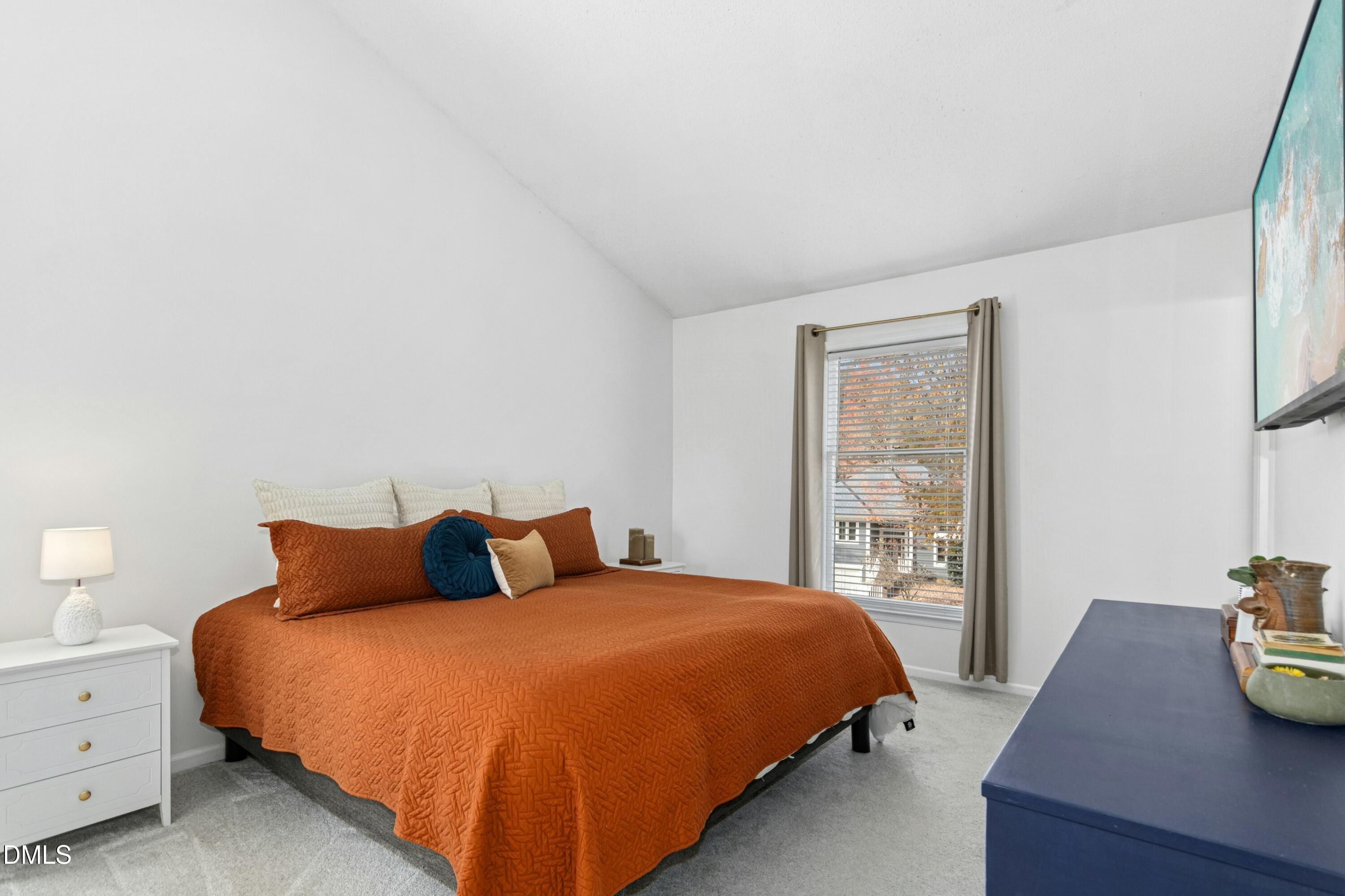 8616 Vanburgh Court Raleigh, NC 27615 - Photo 23 of 38 a bedroom with a bed and window