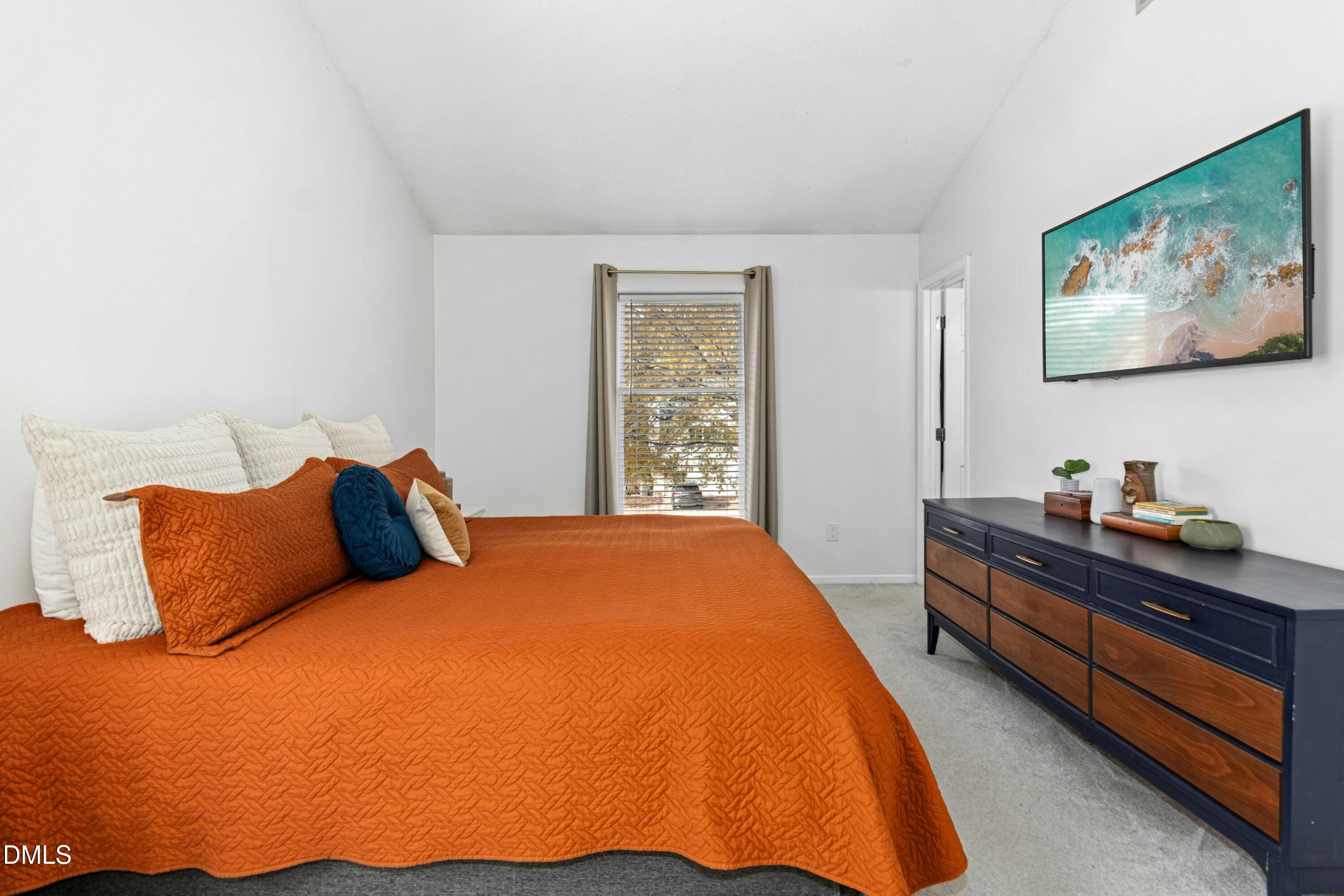 8616 Vanburgh Court Raleigh, NC 27615 - Photo 24 of 38 a bedroom with bed and window