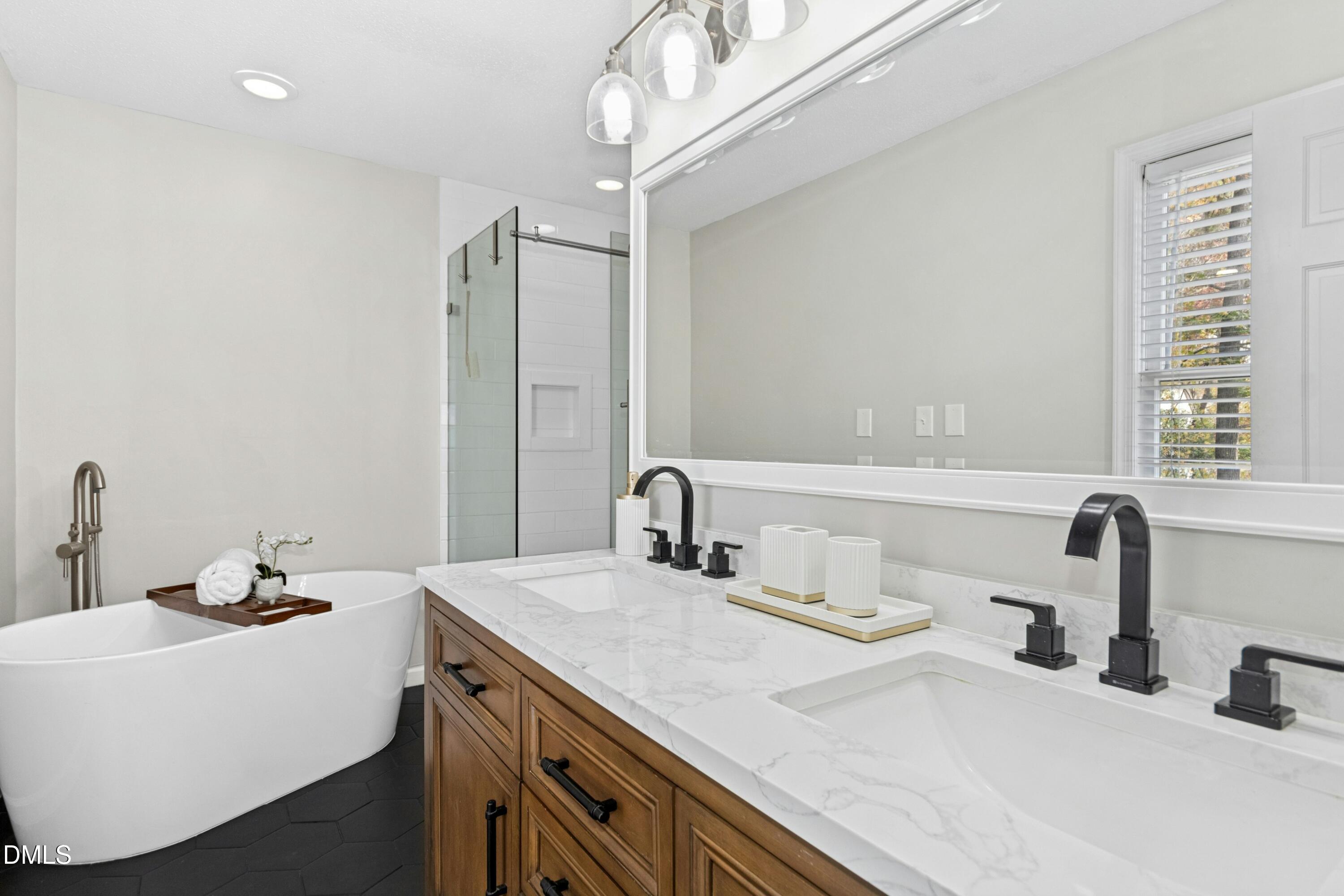 8616 Vanburgh Court Raleigh, NC 27615 - Photo 28 of 38 a bathroom with a sink and a mirror