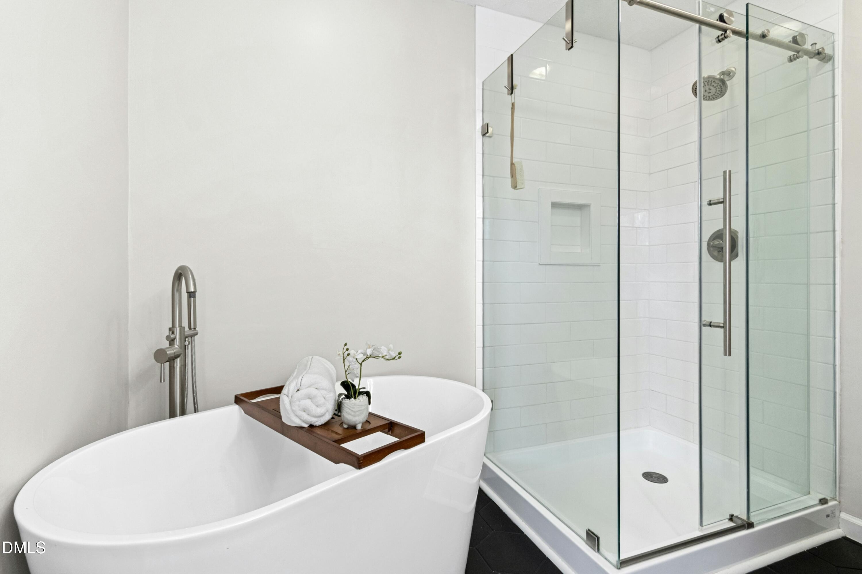 8616 Vanburgh Court Raleigh, NC 27615 - Photo 29 of 38 a bathroom with a tub and sink