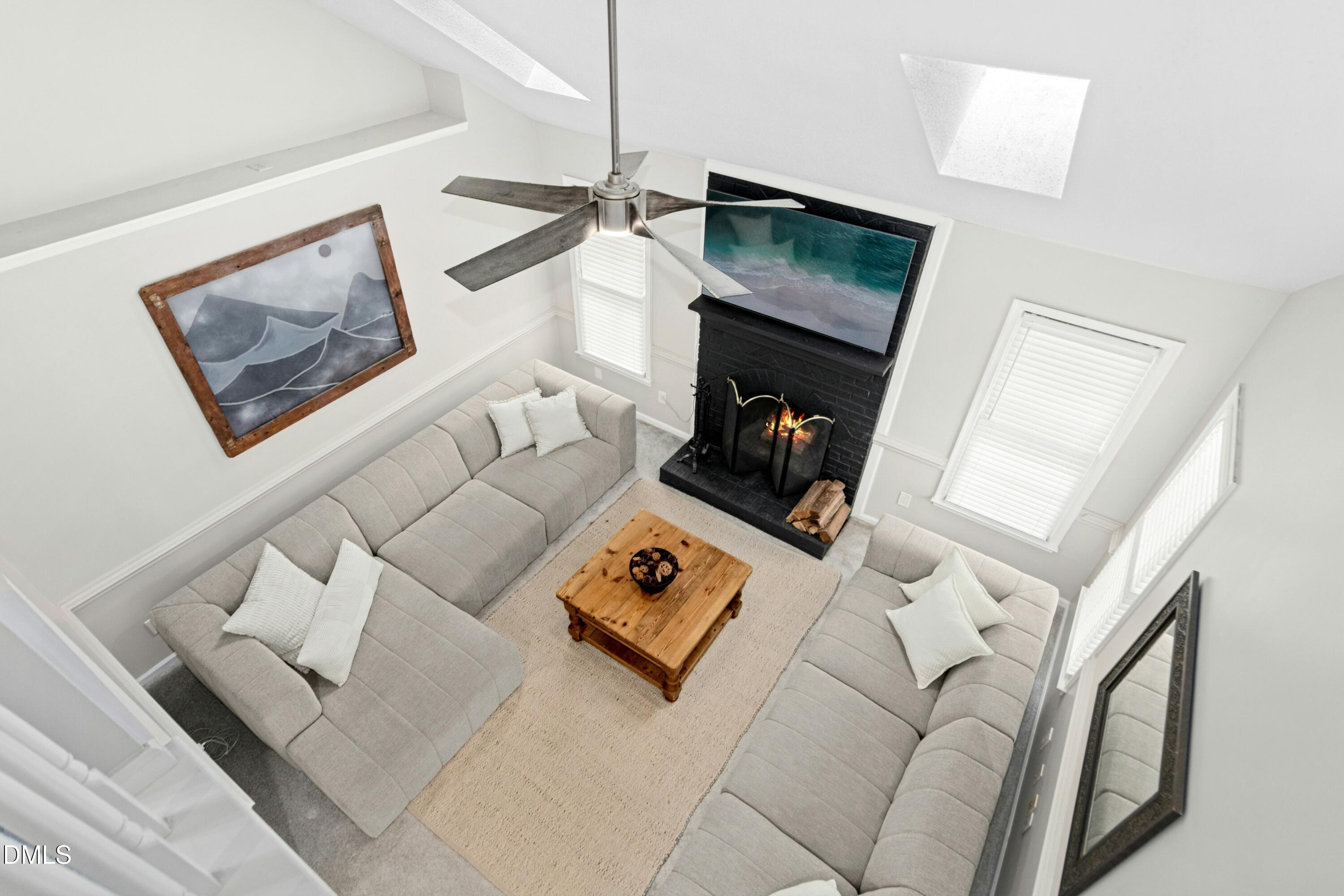 8616 Vanburgh Court Raleigh, NC 27615 - Photo 30 of 38 a living room with furniture and a flat screen tv