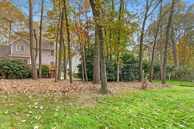 a backyard of a house with lots of green space and fountain