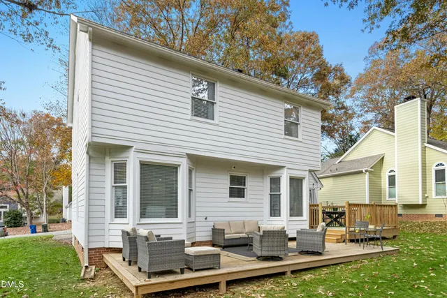 a view of a house with backyard sitting area and garden