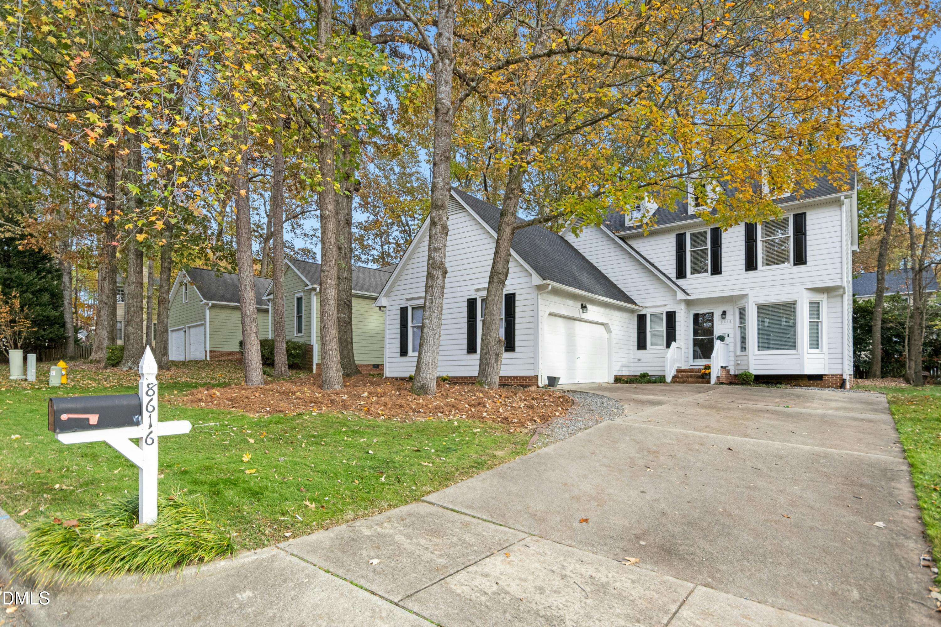 8616 Vanburgh Court Raleigh, NC 27615 - Photo 38 of 38 a front view of a house with a garden and trees