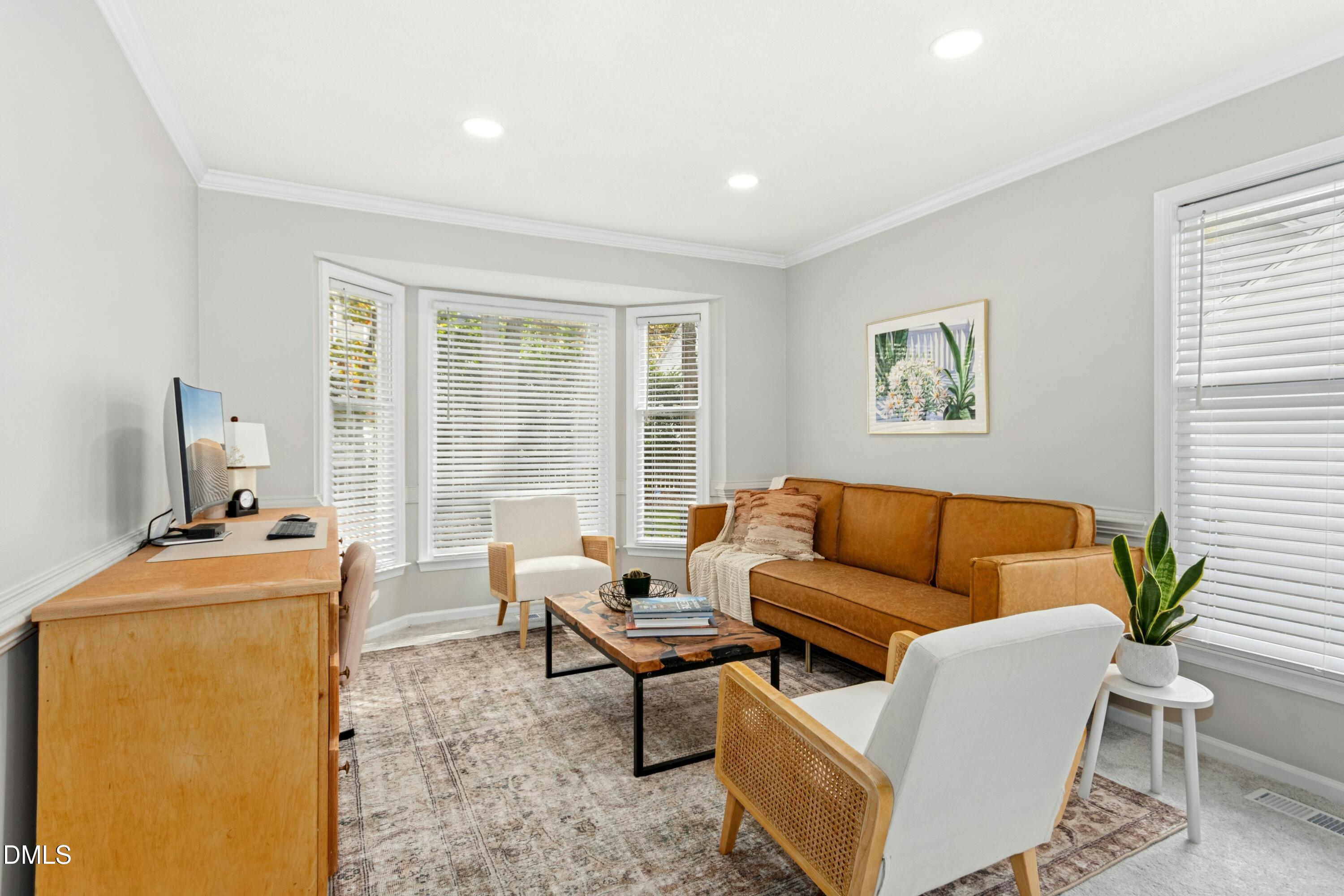 8616 Vanburgh Court Raleigh, NC 27615 - Photo 4 of 38 a living room with furniture and a flat screen tv