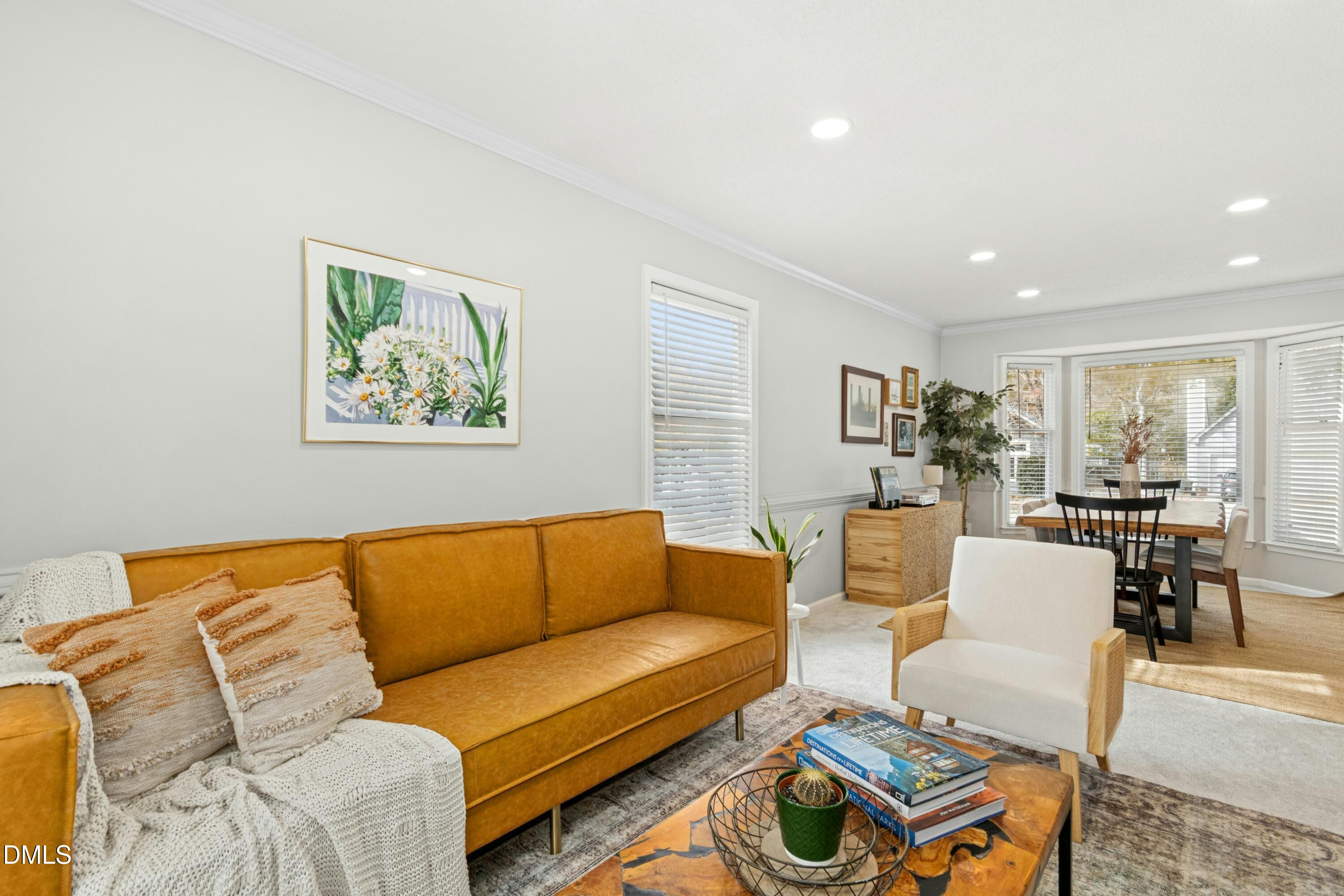 8616 Vanburgh Court Raleigh, NC 27615 - Photo 6 of 38 a living room with furniture kitchen view and a window