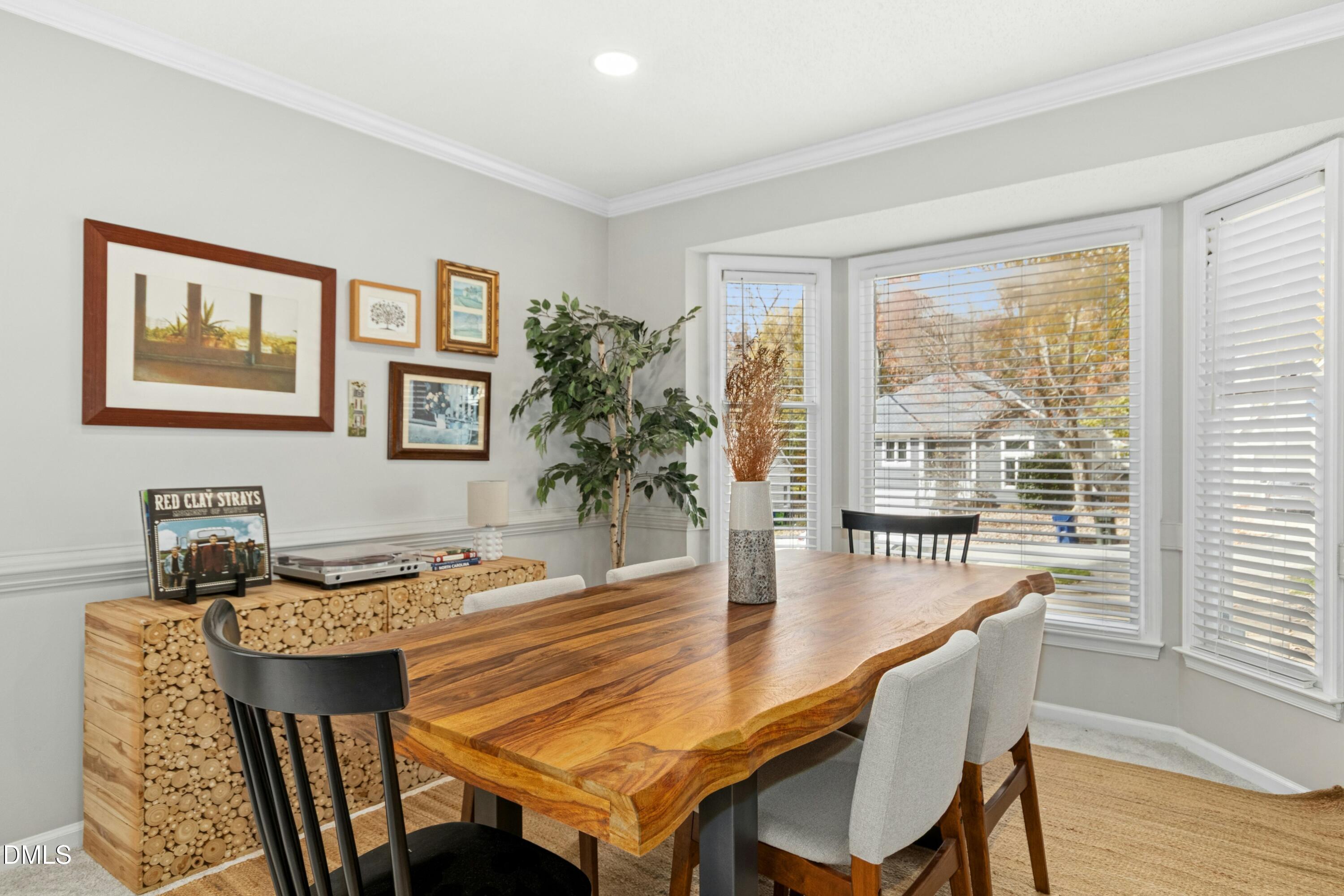8616 Vanburgh Court Raleigh, NC 27615 - Photo 7 of 38 a dining room with furniture and wooden floor
