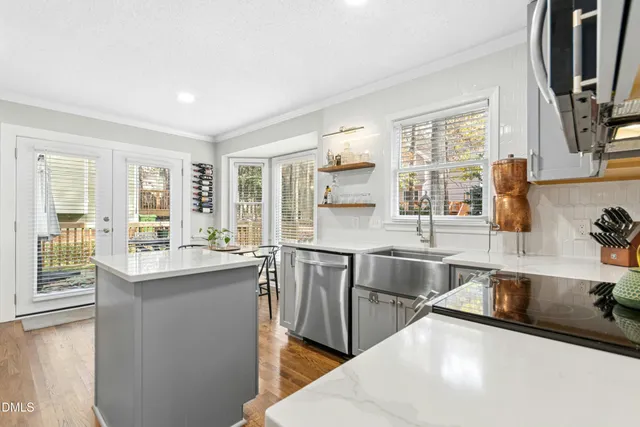 a kitchen with stainless steel appliances granite countertop a sink and a stove