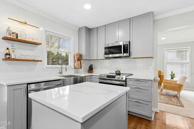 a kitchen with a stove a sink and a microwave