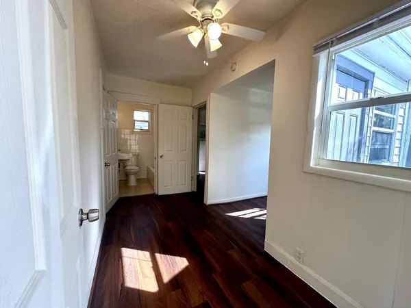 wooden floor in an empty room with a window