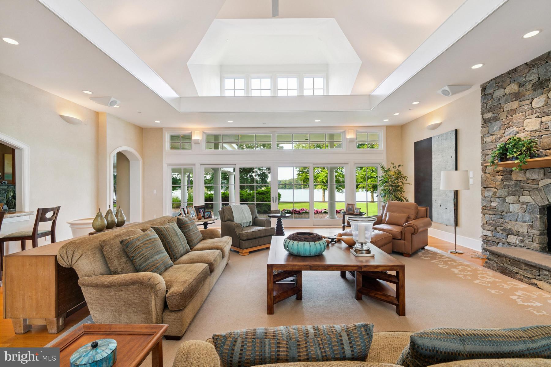 7090 Cooper Point Road Bozman, MD 21612 - Photo 17 of 86 a living room with furniture and a large window