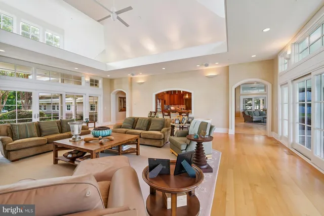 a living room with furniture a fireplace and a floor to ceiling window