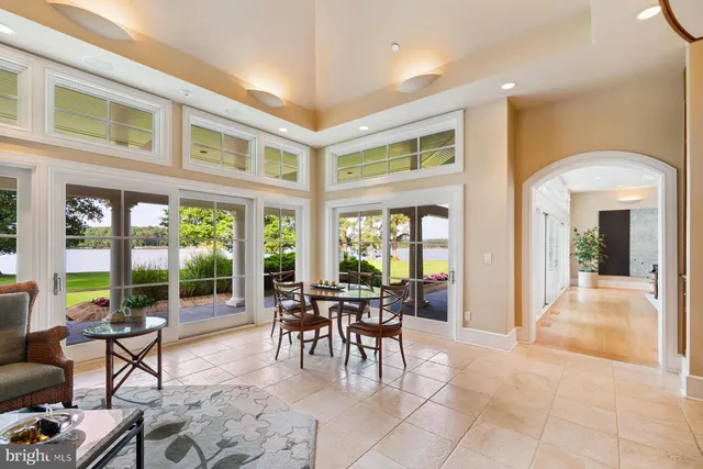a spacious bedroom with a bed and glass door