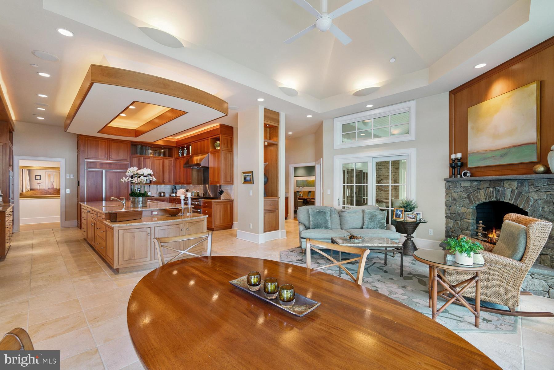 7090 Cooper Point Road Bozman, MD 21612 - Photo 29 of 86 a living room with furniture a flat screen tv and a fireplace