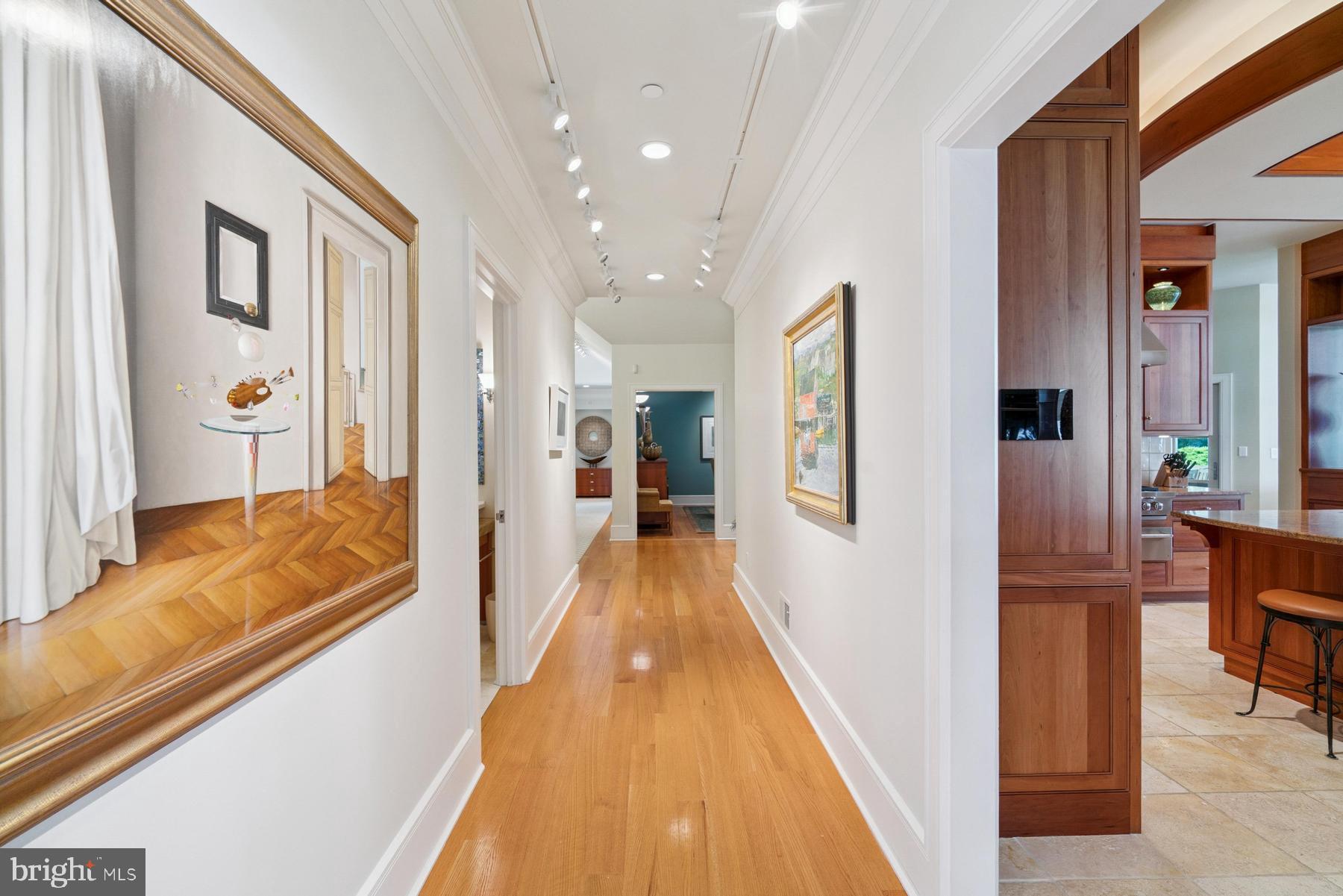 7090 Cooper Point Road Bozman, MD 21612 - Photo 34 of 86 a view of a hallway with wooden floor and furniture