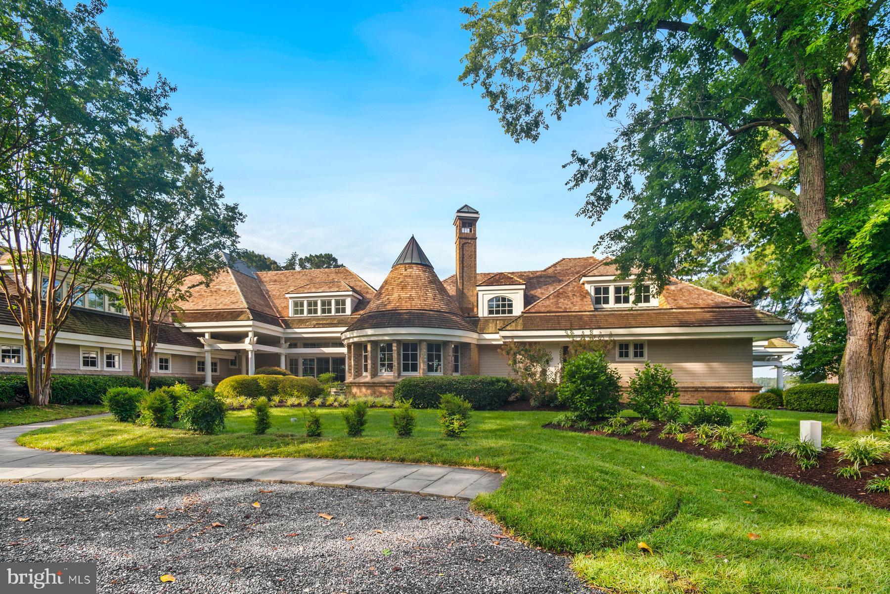 7090 Cooper Point Road Bozman, MD 21612 - Photo 4 of 86 a front view of a house with a yard and potted plants