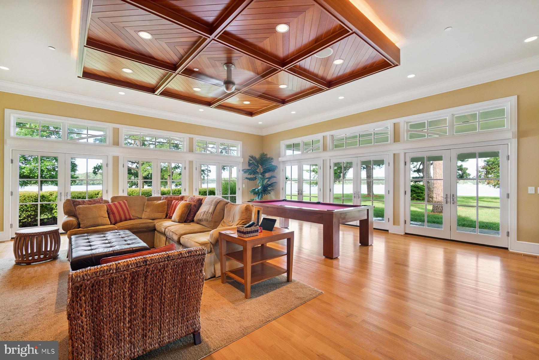 7090 Cooper Point Road Bozman, MD 21612 - Photo 42 of 86 a living room with fireplace furniture and a large window