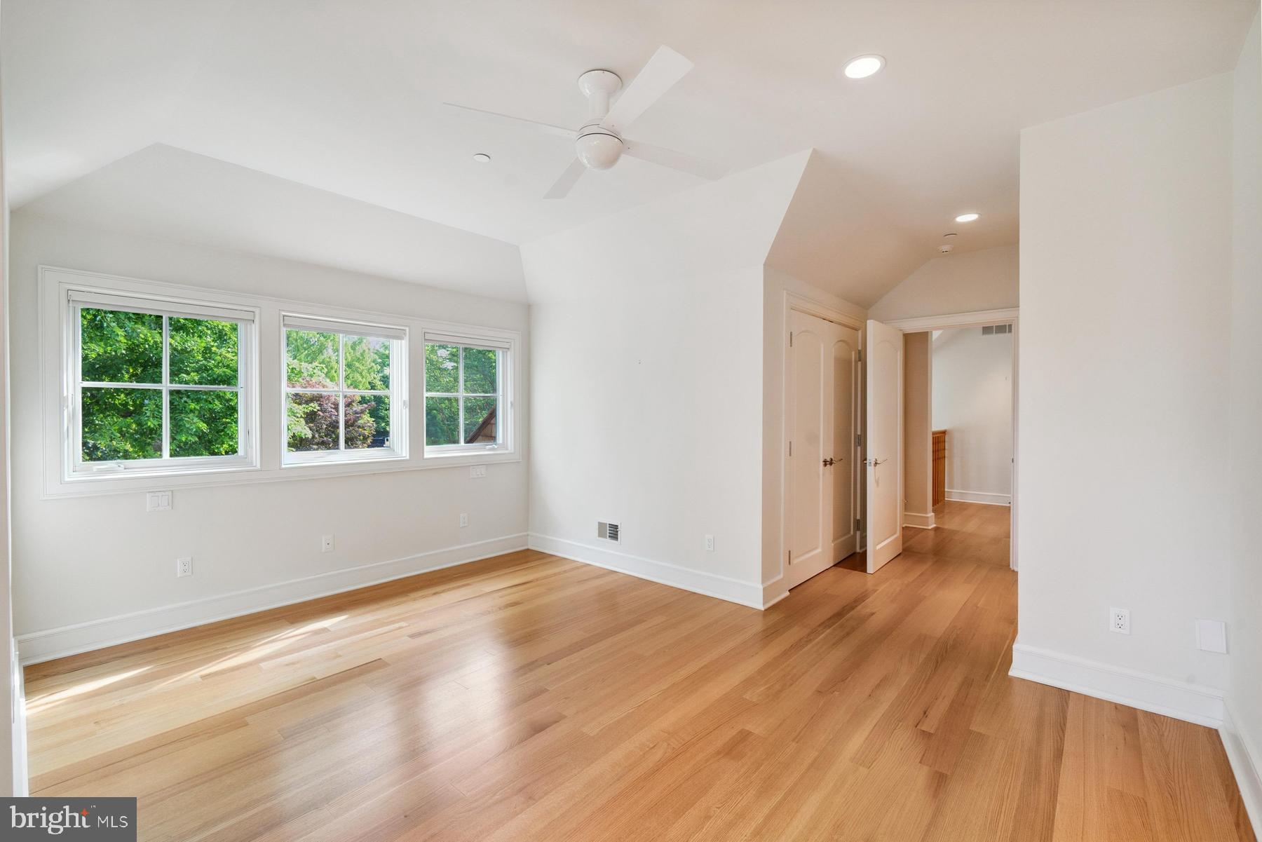 7090 Cooper Point Road Bozman, MD 21612 - Photo 50 of 86 a view of an empty room with wooden floor and a window