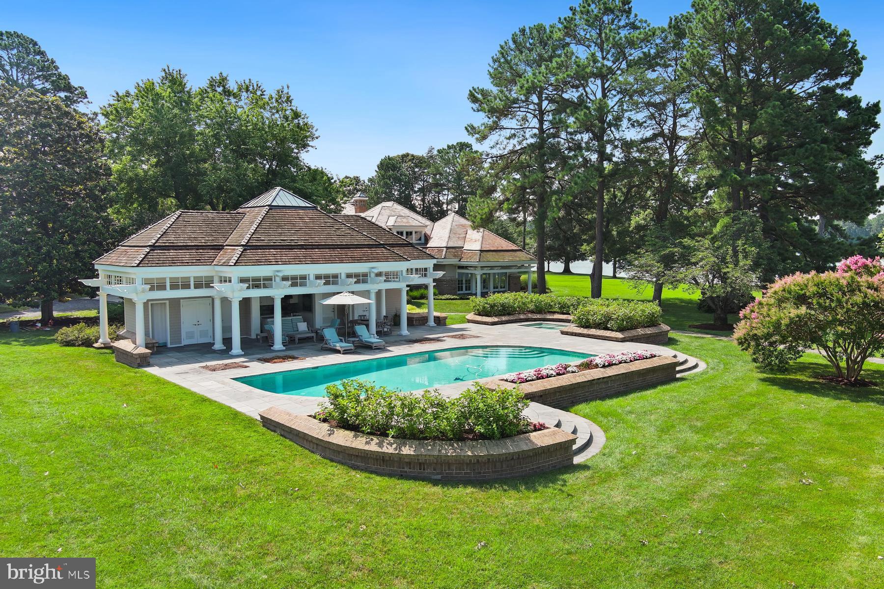 7090 Cooper Point Road Bozman, MD 21612 - Photo 57 of 86 a front view of a house with a yard table and chairs