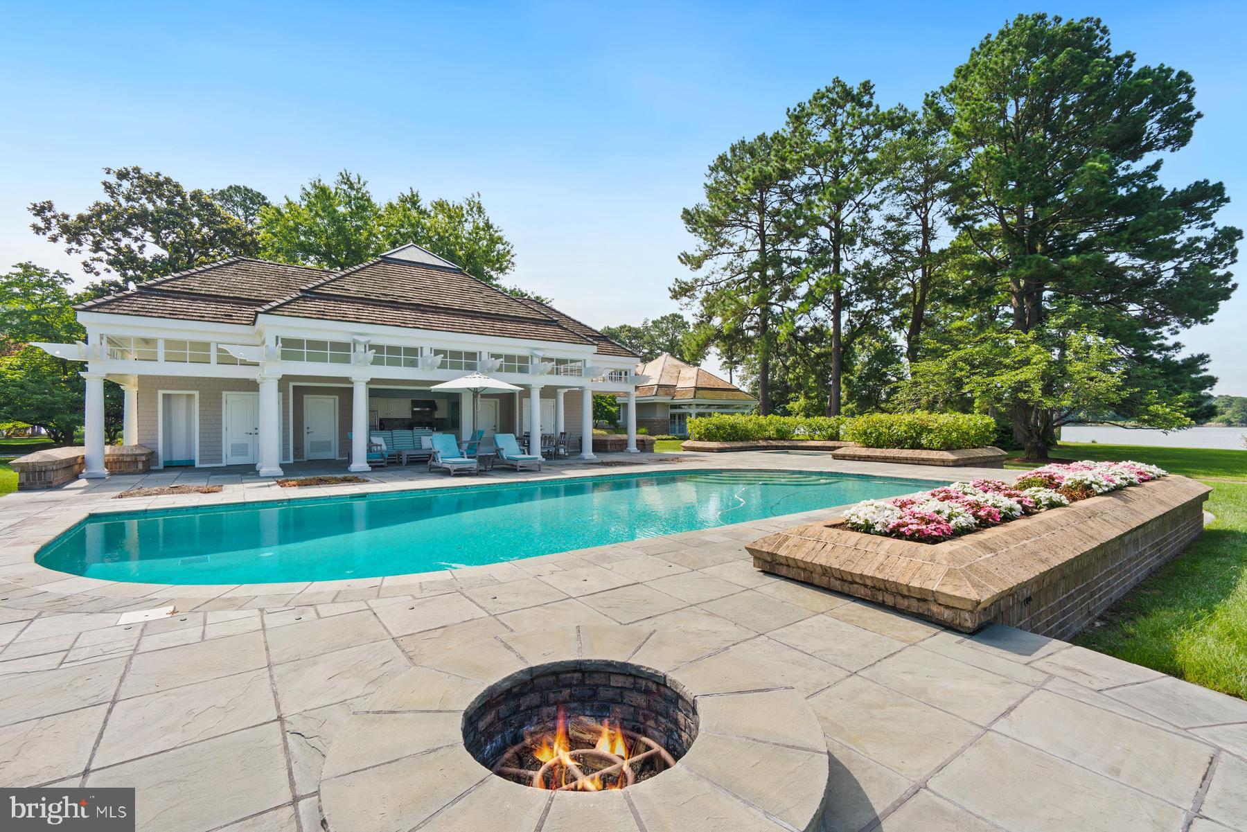 7090 Cooper Point Road Bozman, MD 21612 - Photo 59 of 86 a view of a house with swimming pool and yard